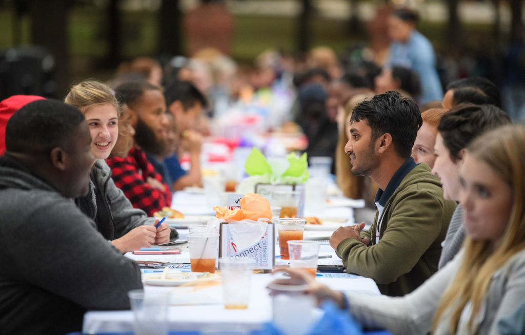 Students, faculty and staff meet for dinner and conversation at The Longest Table. 